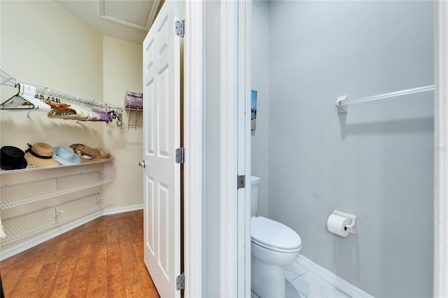 bathroom featuring hardwood / wood-style flooring and toilet