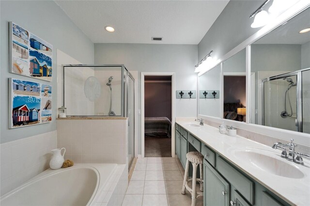 bathroom with vanity, plus walk in shower, and tile patterned flooring