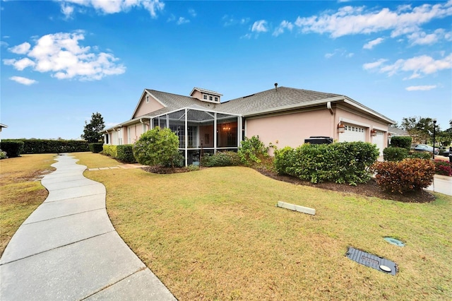 ranch-style house featuring a garage, a lanai, and a front yard