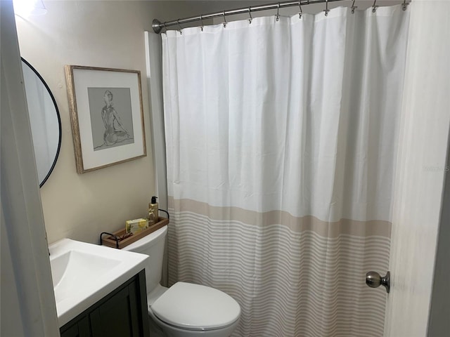 bathroom featuring toilet and vanity