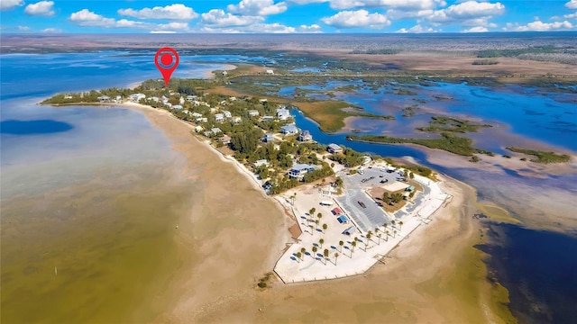 drone / aerial view featuring a water view and a view of the beach