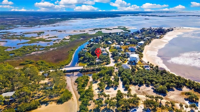 birds eye view of property featuring a water view and a view of the beach