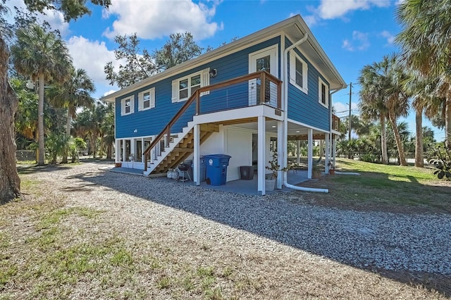 rear view of house with a patio and a yard