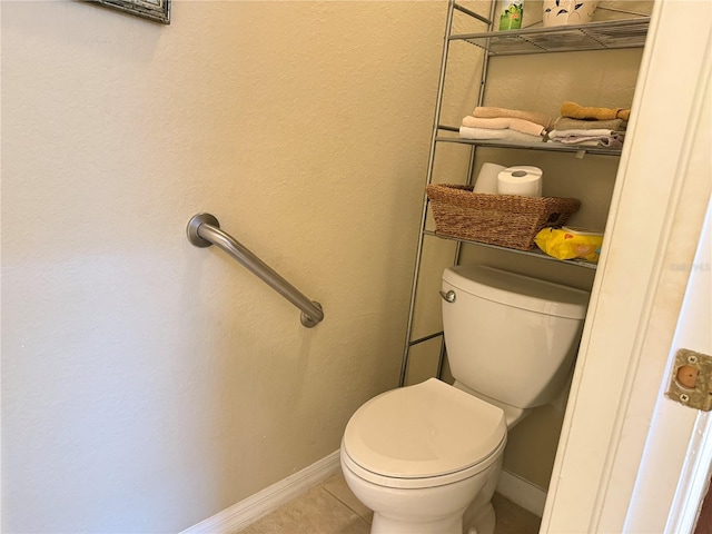 bathroom with tile patterned flooring and toilet