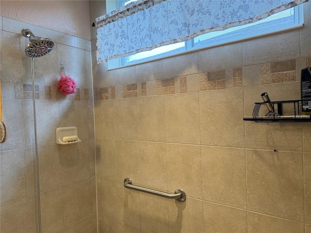 bathroom with a tile shower