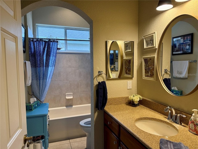 full bathroom featuring vanity, tile patterned floors, shower / bath combo with shower curtain, and toilet