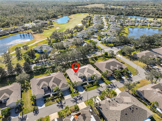 aerial view with a water view, view of golf course, and a residential view