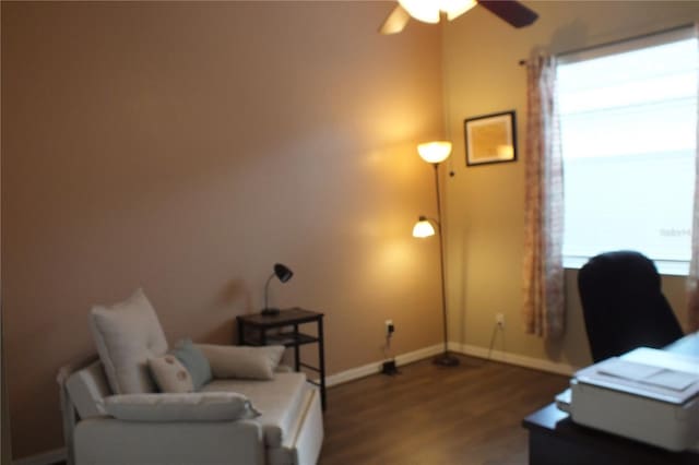 office area with a ceiling fan, baseboards, and wood finished floors