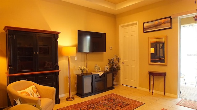 sitting room featuring light tile patterned floors and baseboards