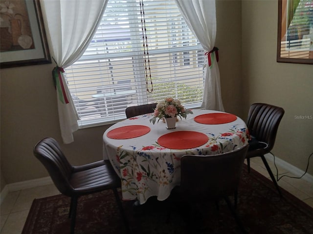 dining space with baseboards and tile patterned floors