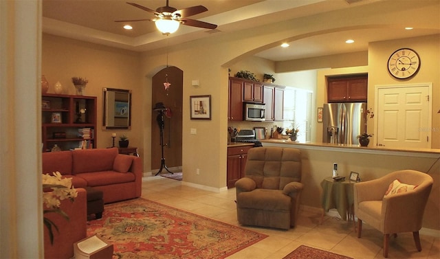 living room featuring arched walkways, ceiling fan, light tile patterned floors, and recessed lighting