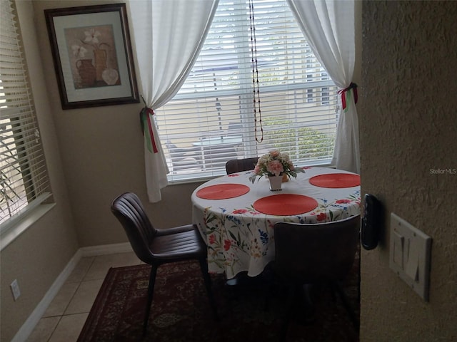 dining room featuring light tile patterned floors and baseboards