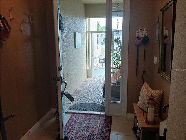 doorway to outside featuring tile patterned floors