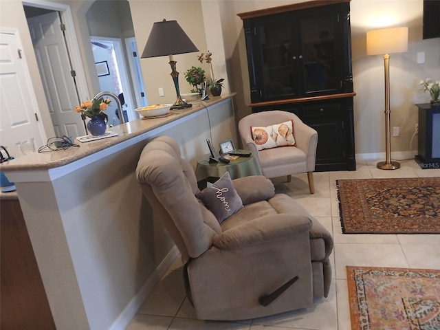 living room with baseboards and light tile patterned floors