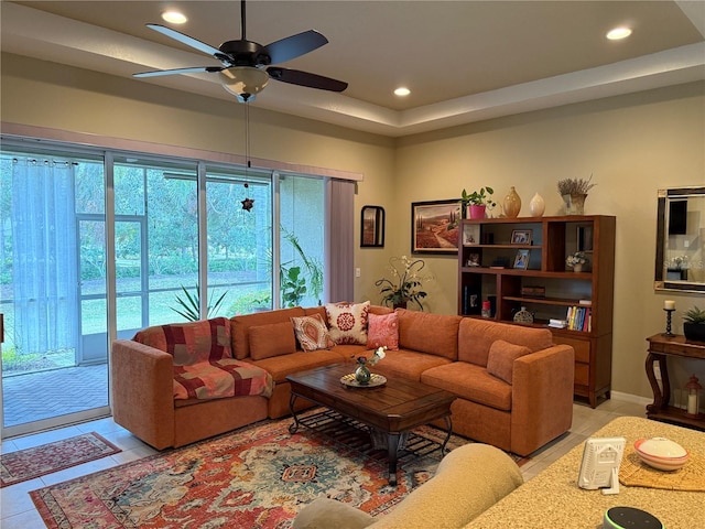 living area featuring light tile patterned floors, a ceiling fan, and recessed lighting