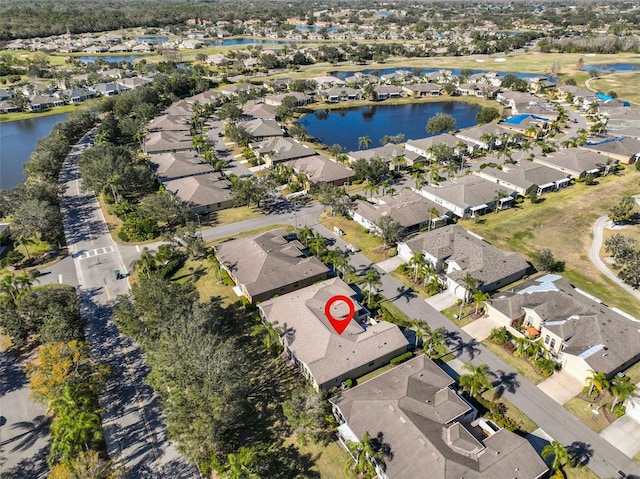 drone / aerial view with a residential view and a water view