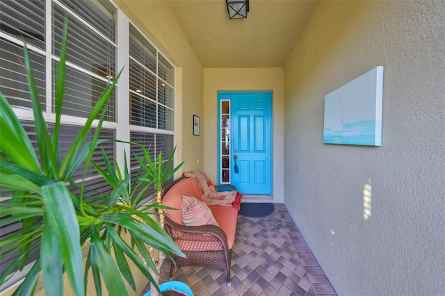 property entrance with stucco siding