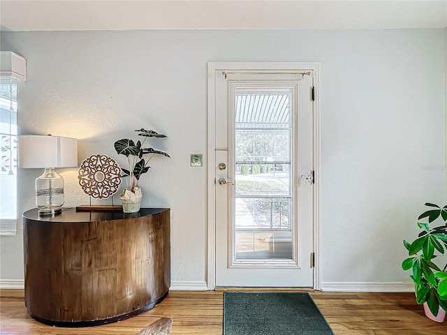 doorway with a healthy amount of sunlight and light wood-type flooring