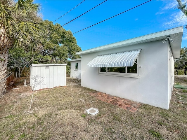 view of home's exterior with a storage shed