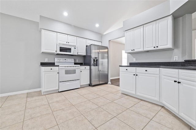 kitchen featuring white appliances and white cabinetry