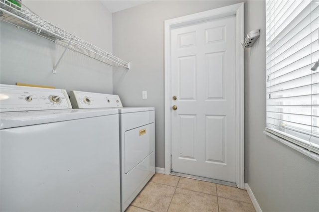 clothes washing area featuring independent washer and dryer and light tile patterned flooring