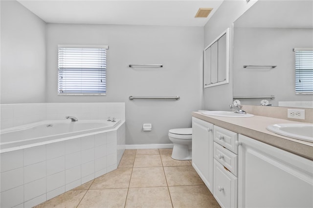 bathroom with tiled bath, toilet, tile patterned flooring, and vanity