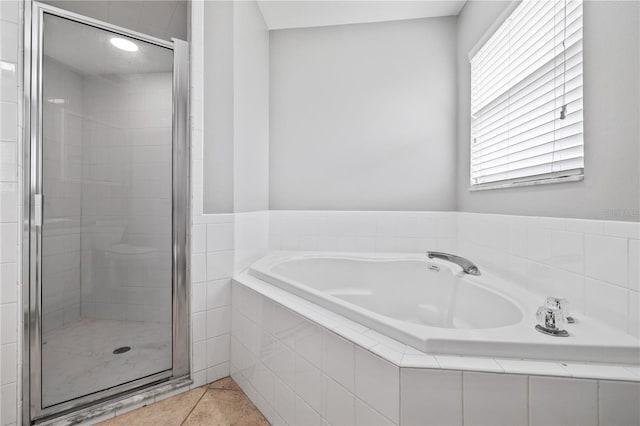 bathroom with a wealth of natural light, tile patterned floors, and shower with separate bathtub