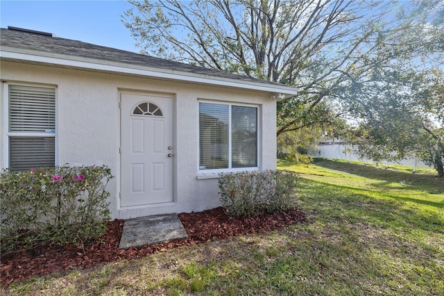 property entrance with a yard