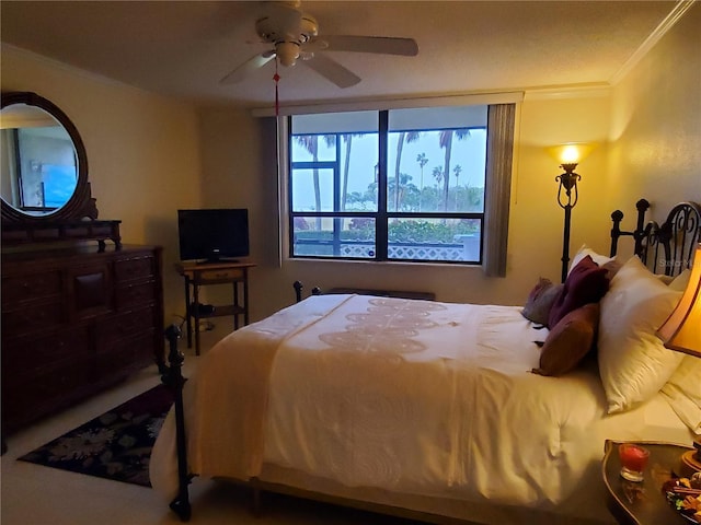 bedroom featuring ceiling fan and crown molding