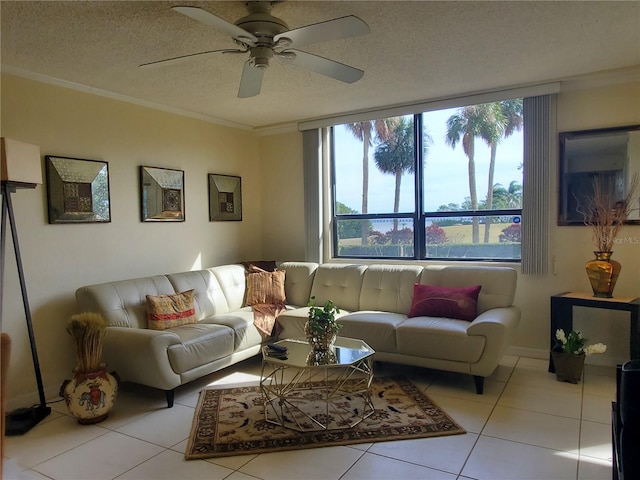 living room featuring ceiling fan, crown molding, a textured ceiling, and light tile patterned floors