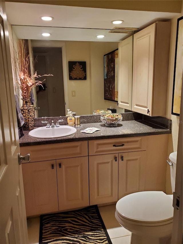 bathroom with recessed lighting, vanity, and toilet