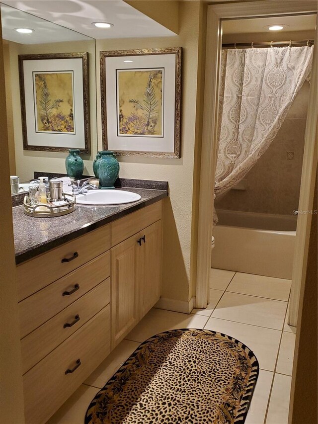 bathroom with vanity, shower / bath combination with curtain, and tile patterned floors