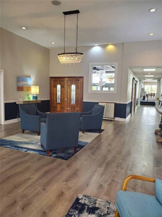 living room with recessed lighting, wood finished floors, and baseboards