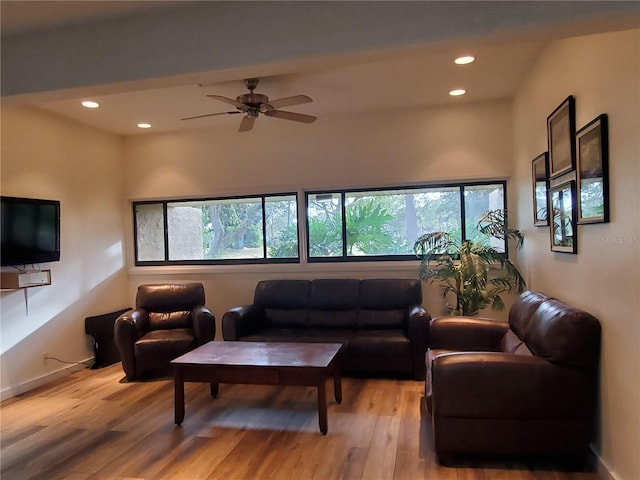 living room featuring a ceiling fan, recessed lighting, baseboards, and light wood finished floors