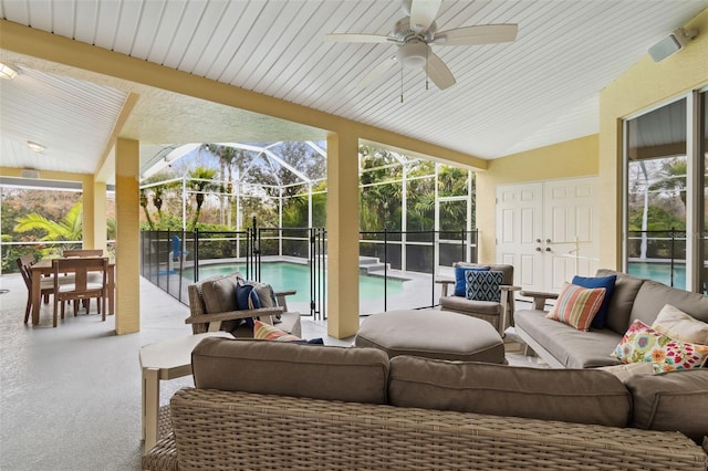 sunroom / solarium featuring ceiling fan, vaulted ceiling, and a wealth of natural light