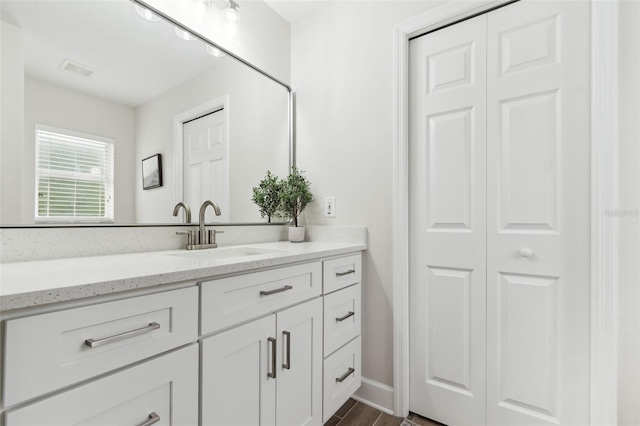 bathroom with vanity and wood-type flooring