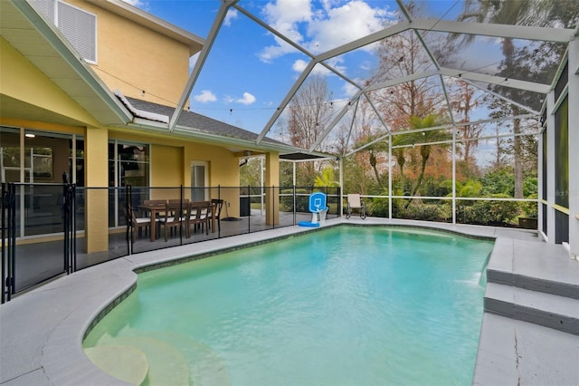 view of pool featuring a patio area, pool water feature, and glass enclosure