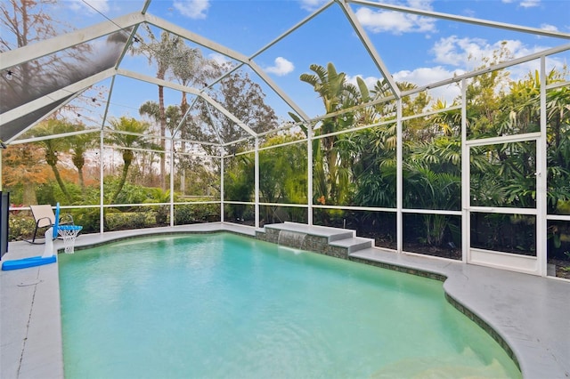 view of swimming pool featuring pool water feature, a patio, and glass enclosure