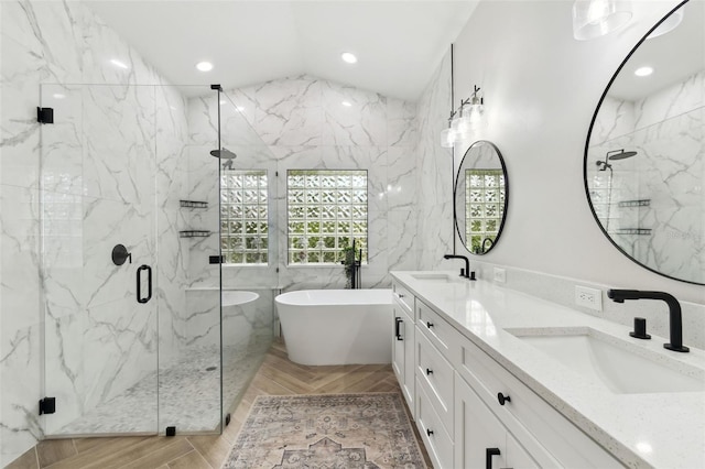 bathroom featuring lofted ceiling, vanity, shower with separate bathtub, and tile walls