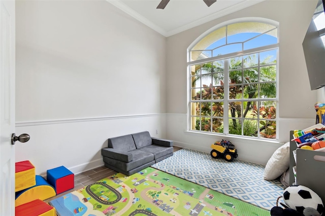 game room with ceiling fan, ornamental molding, and hardwood / wood-style floors