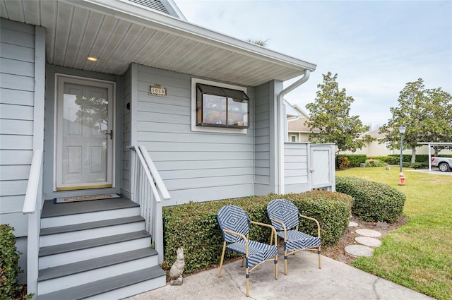 view of exterior entry featuring a yard