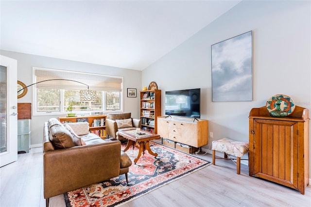 living room with vaulted ceiling and light wood-type flooring