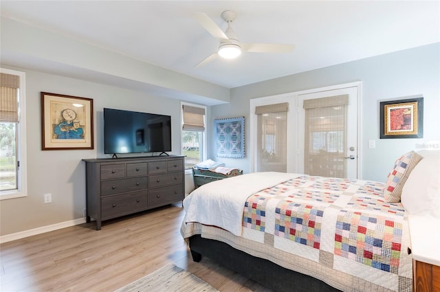 bedroom featuring access to exterior, light hardwood / wood-style floors, and ceiling fan