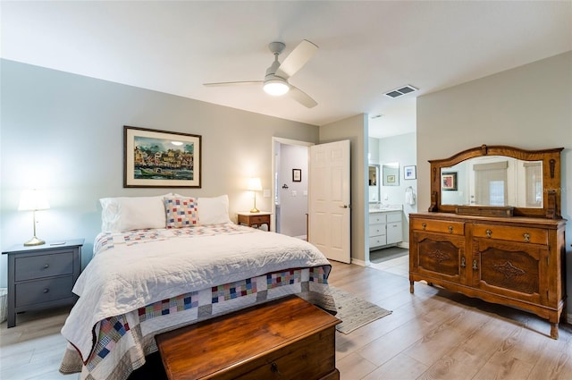 bedroom with connected bathroom, ceiling fan, and light hardwood / wood-style flooring