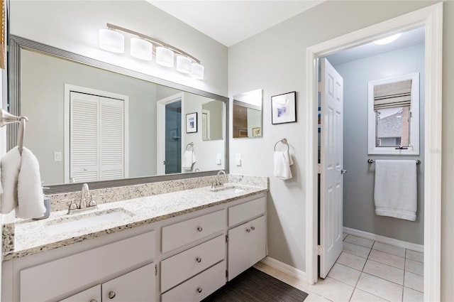 bathroom featuring tile patterned flooring and vanity