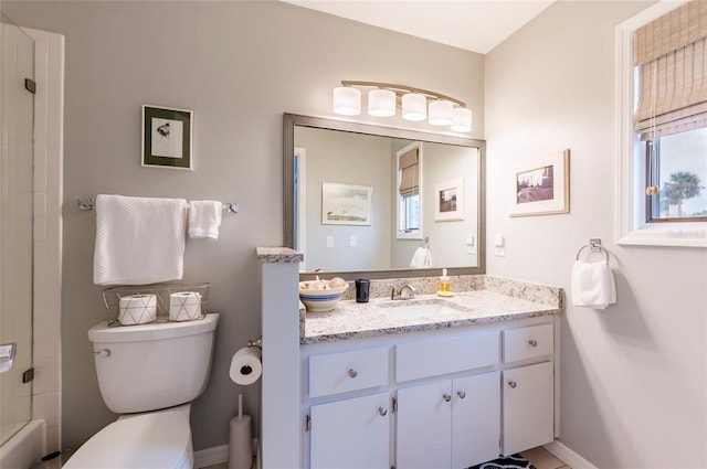 bathroom featuring vanity, a shower, and toilet