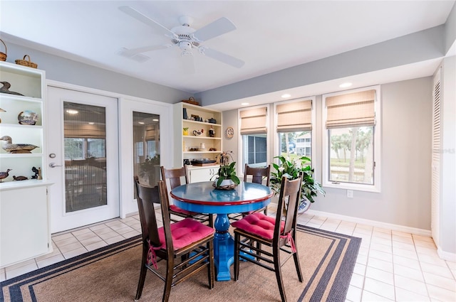 tiled dining space with ceiling fan