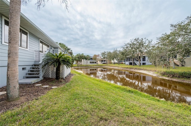 1018 Caravel Ct, Tarpon Springs, FL 34689 - view of grassy yard with a water view and stairway