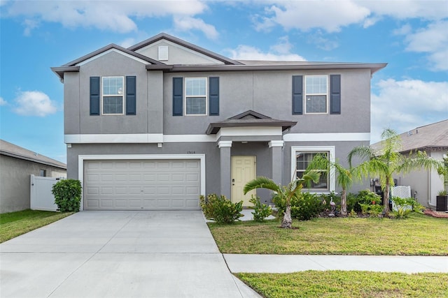 view of front of home featuring a garage, central AC, and a front yard