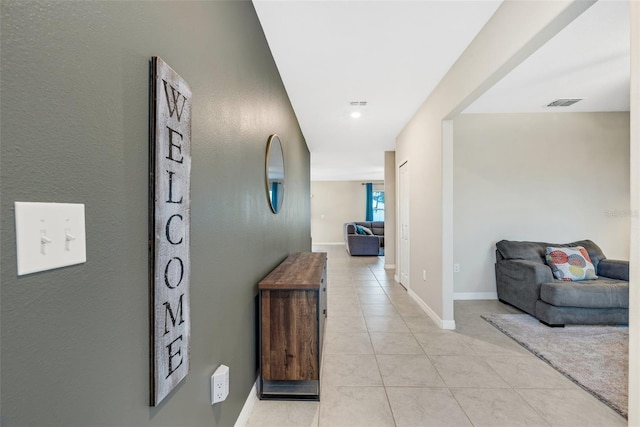 hall featuring light tile patterned flooring